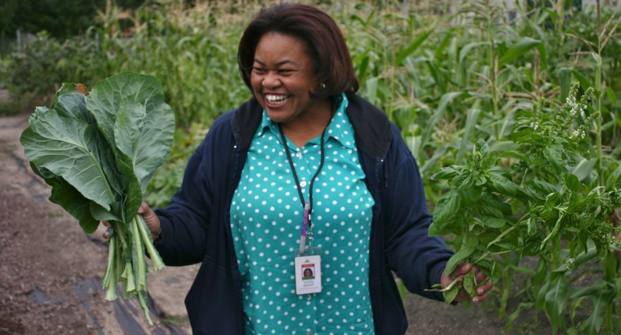 Smiling woman holding vegetables